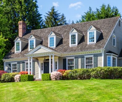 Exterior of a colonial house and a manicured lawn. Bosshard Parke Estate Planning and Taxes.