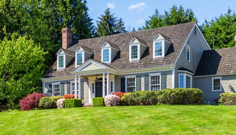 Exterior of a colonial house and a manicured lawn. Bosshard Parke Estate Planning and Taxes.