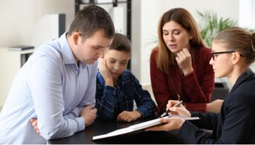 Family looks at paperwork with an attorney. Bosshard Parke legal separation versus divorce Wisconsin law.