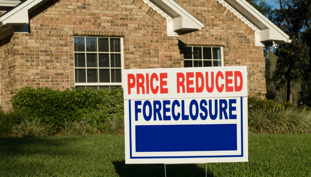 Home with foreclosure sign in front of it. Bosshard Parke Foreclosure Action in Wisconsin.