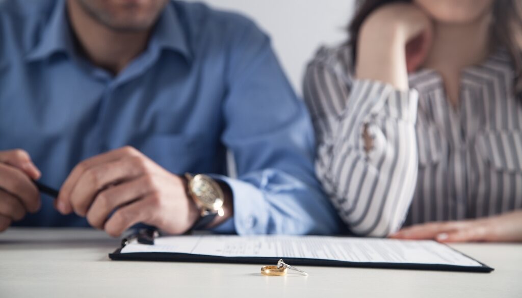 Husband and wife fill out divorce papers. Bosshard Parke Dissolution of Marriage in Minnesota.