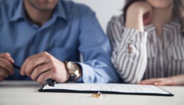 Husband and wife fill out divorce papers. Bosshard Parke Dissolution of Marriage in Minnesota.