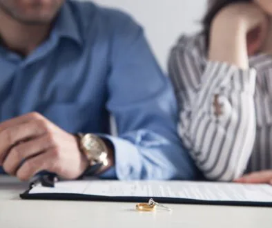 Husband and wife fill out divorce papers. Bosshard Parke Dissolution of Marriage in Minnesota.