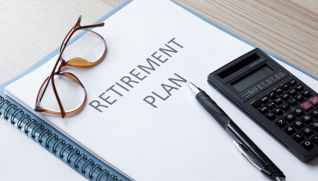 Retirement plan binder with glasses and a calculator. Bosshard Parke Secure Act.