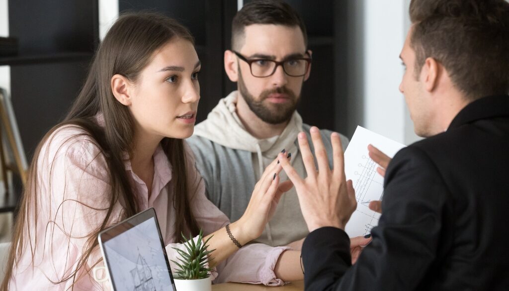 A couple argues with their attorney over an estate planning dispute. Bosshard Parke, La Crosse WI estate planning attorneys.