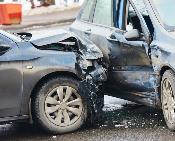 Two vehicles smashed and broken from a car accident. Car Accident and Personal Injury Law at Bosshard Parke in La Crosse, WI.