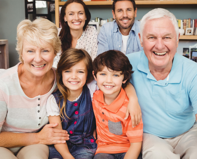 Grandparents smile with their grandkids. The children's parents smile behind them. Estate Planning Law at Bosshard Parke in La Crosse, WI.