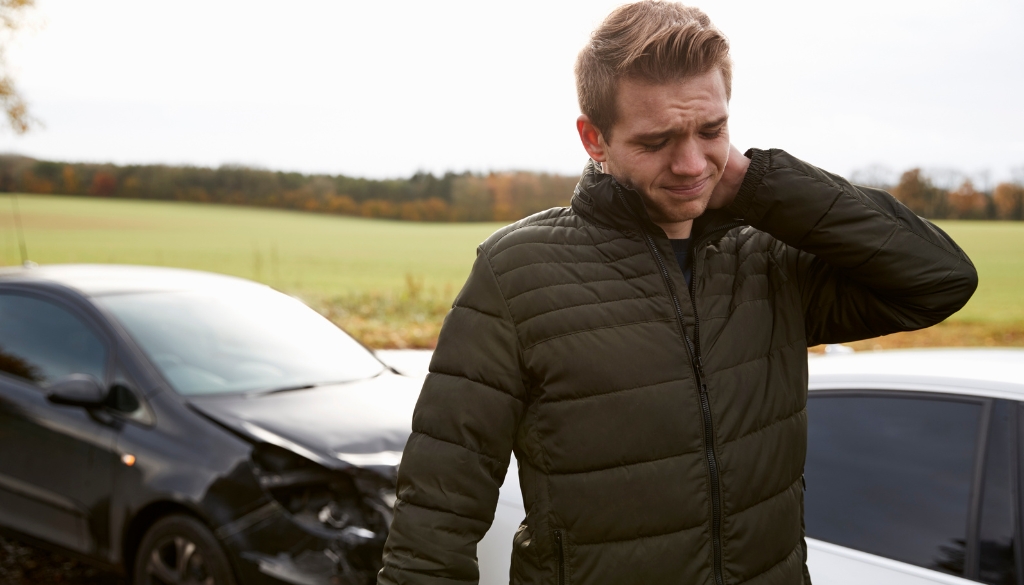 Man scratching his neck after being involved in a car accident in Wisconsin.