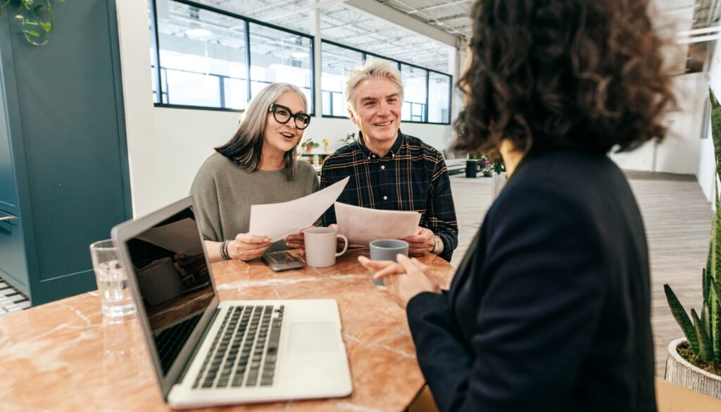 An older couple sitting down with a professional at Bosshard Parke for estate planning.