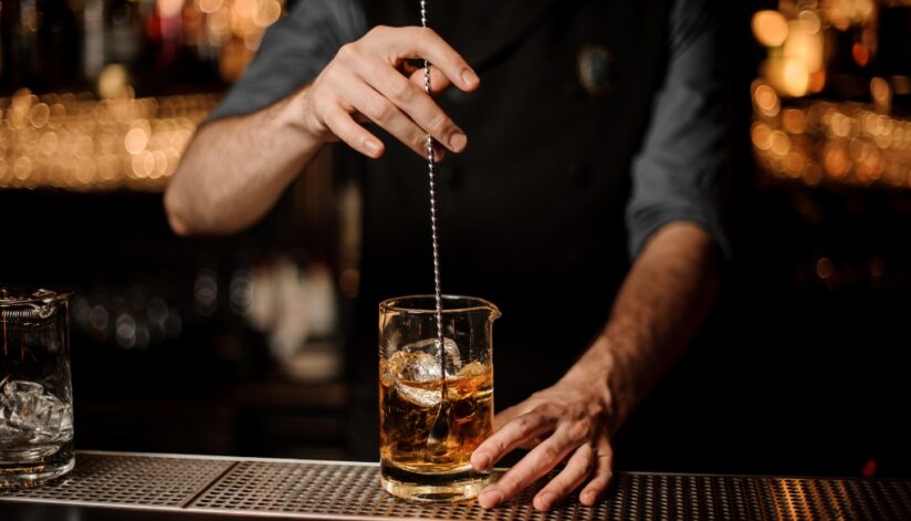 A bartender preparing a cocktail.