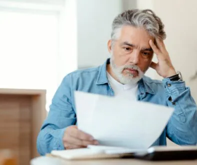 Concerned man reviewing medical bills at home, trying to understand how medical payment insurance (Med Pay) coverage works in Wisconsin personal injury cases.