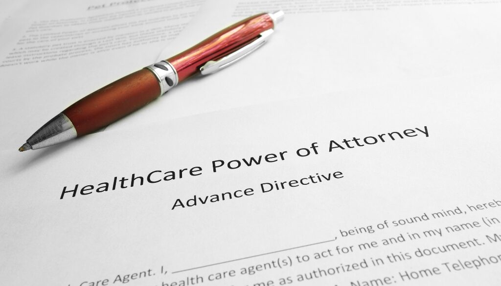 A red pen resting on a health care power of attorney (advance directive) document for students.