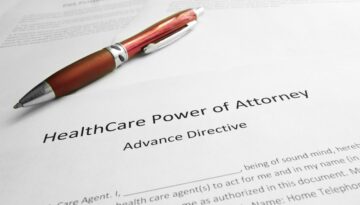 A red pen resting on a health care power of attorney (advance directive) document for students.