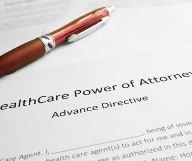 A red pen resting on a health care power of attorney (advance directive) document for students.