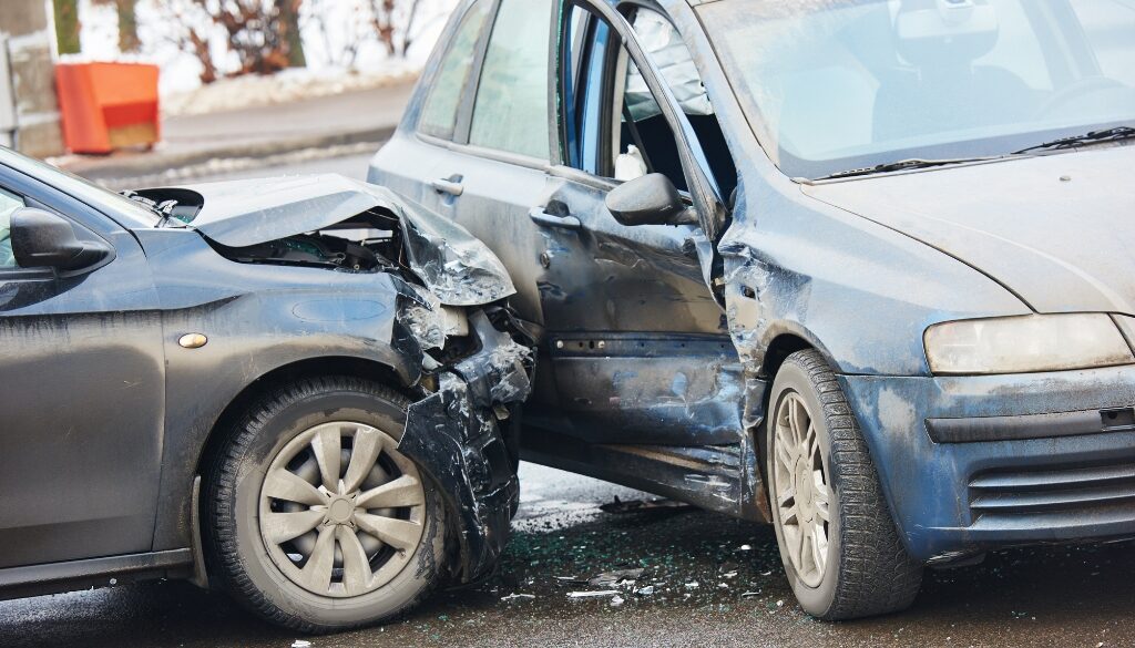 Two damaged cars involved in a winter accident on an icy Wisconsin road.