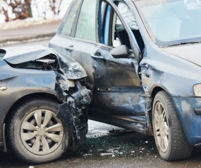 Two damaged cars involved in a winter accident on an icy Wisconsin road.