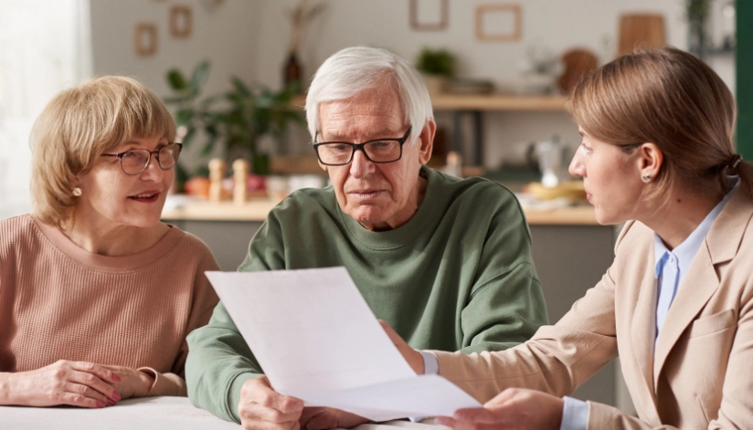 An elderly couple reviewing a document with an experienced estate planning attorney.