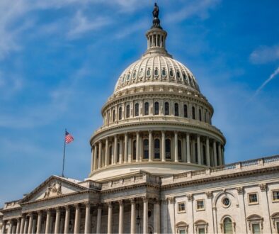 The United States Capitol building under a blue sky,