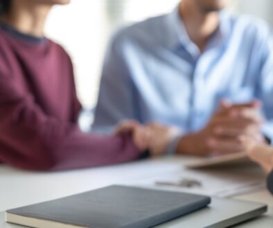 A couple meets with an estate planning attorney to discuss legal documents and plan for their family’s financial future.