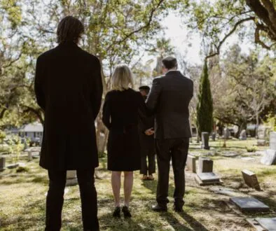 A grieving family at the graveyard for a funeral for a loved one in a wrongful death situation.