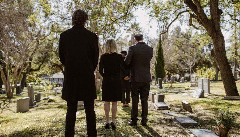 A grieving family at the graveyard for a funeral for a loved one in a wrongful death situation.
