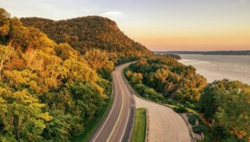 Aerial view of Highway 35 winding through wooded hills beside the Mississippi River near Stockholm, Wisconsin.