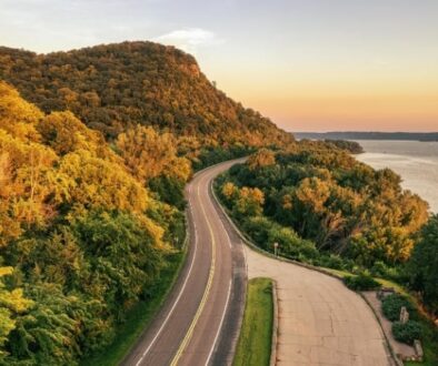 Aerial view of Highway 35 winding through wooded hills beside the Mississippi River near Stockholm, Wisconsin.