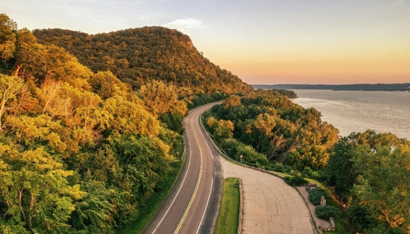 Aerial view of Highway 35 winding through wooded hills beside the Mississippi River near Stockholm, Wisconsin.