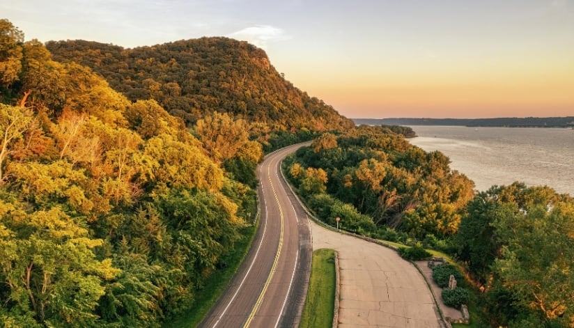 Aerial view of Highway 35 winding through wooded hills beside the Mississippi River near Stockholm, Wisconsin.