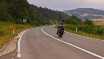 Motorcyclist riding on a winding rural road in Wisconsin.
