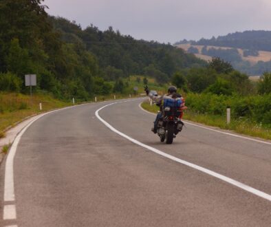 Motorcyclist riding on a winding rural road in Wisconsin.