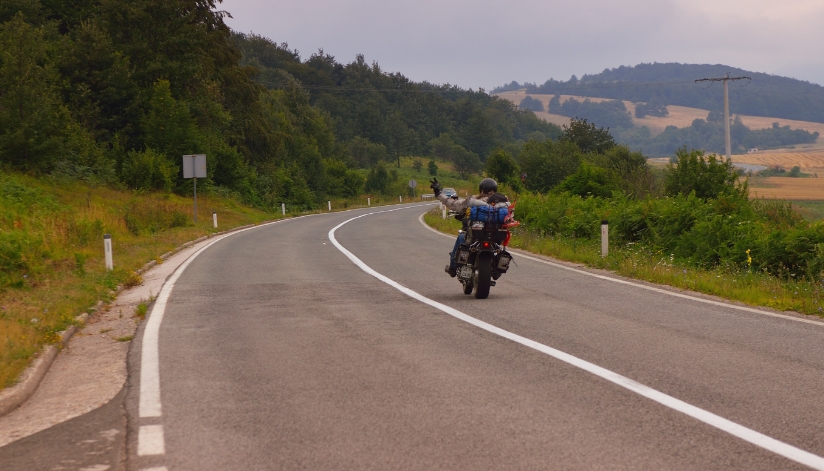 Motorcyclist riding on a winding rural road in Wisconsin.